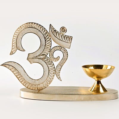 The sacred filigree Om with Diya