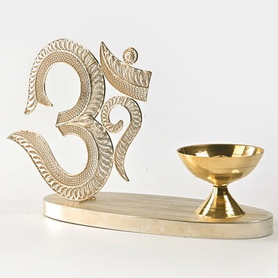 The sacred filigree Om with Diya