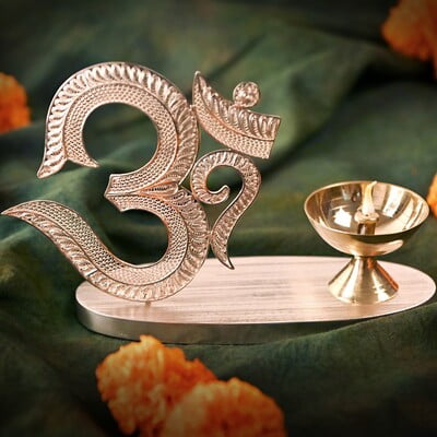 The sacred filigree Om with Diya