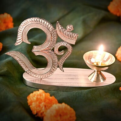 The sacred filigree Om with Diya